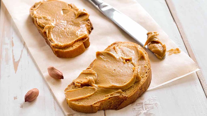 peanut butter spread onto two pieces of bread